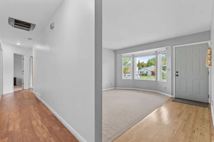 Entryway featuring a bay window, natural wood-finish flooring, and light gray wall tones