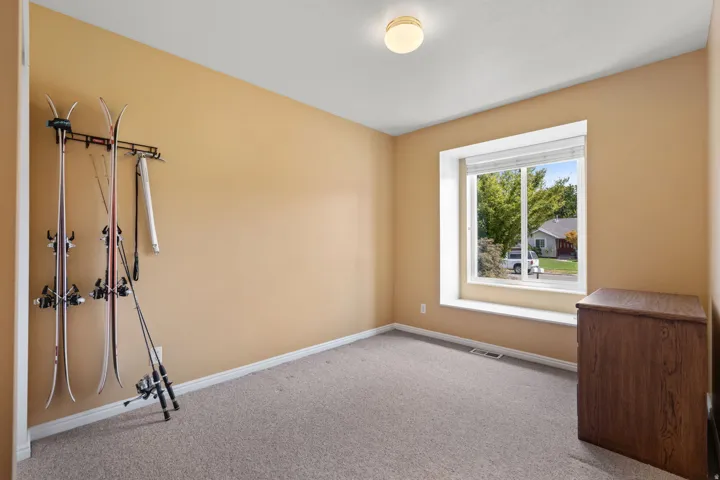Recessed lighting, large window, neutral wall tones, carpet flooring, baseboard trim
