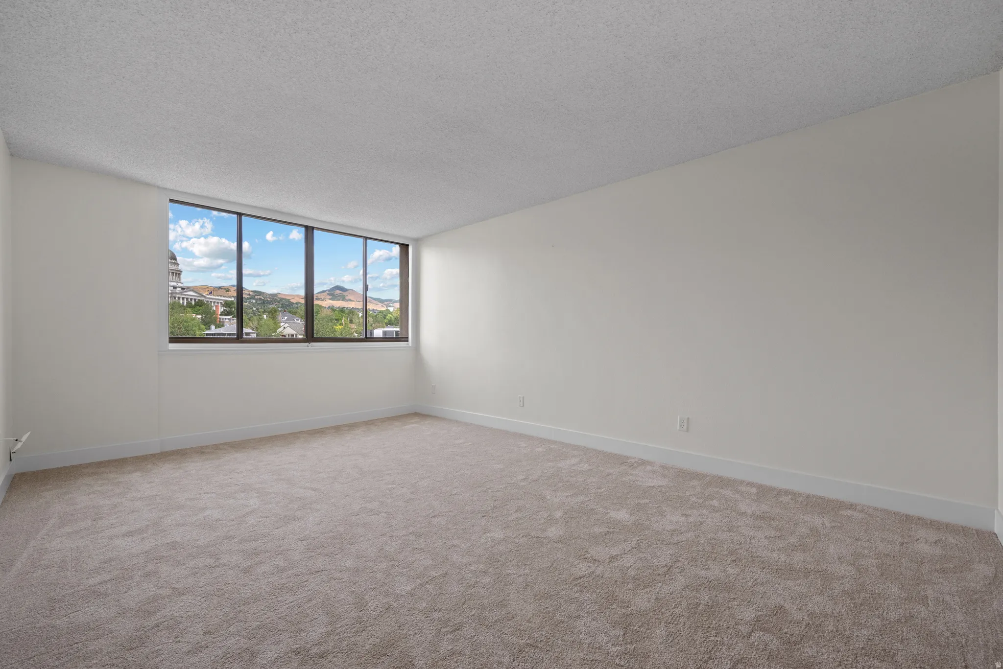 Expansive window with mountain scenery and architectural elements