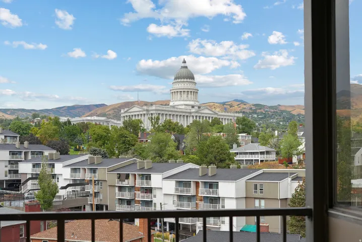 Cityscape with prominent dome building and distant mountains