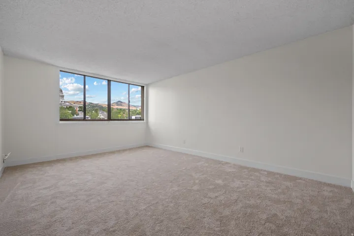 Expansive window with mountain scenery and architectural elements