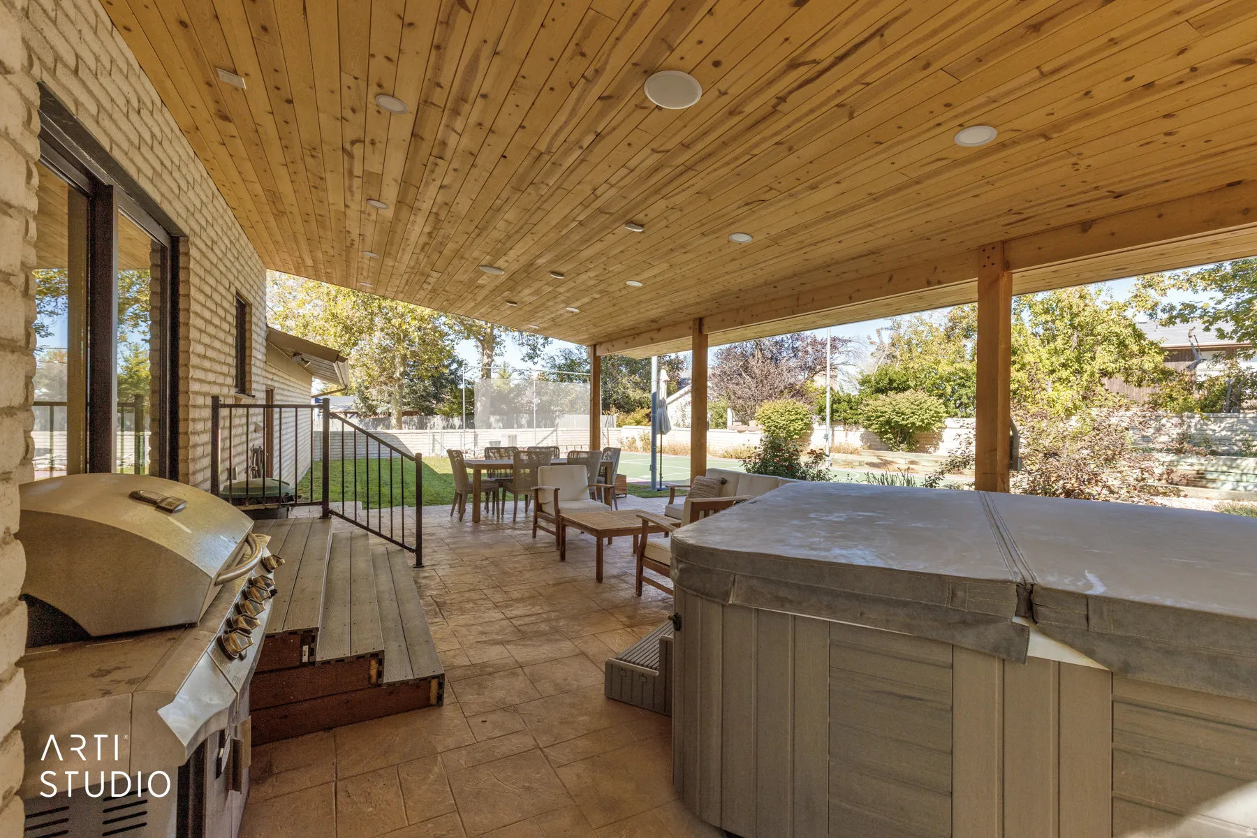 Covered patio with a wood-plank ceiling, recessed lighting, and a stamped concrete surface