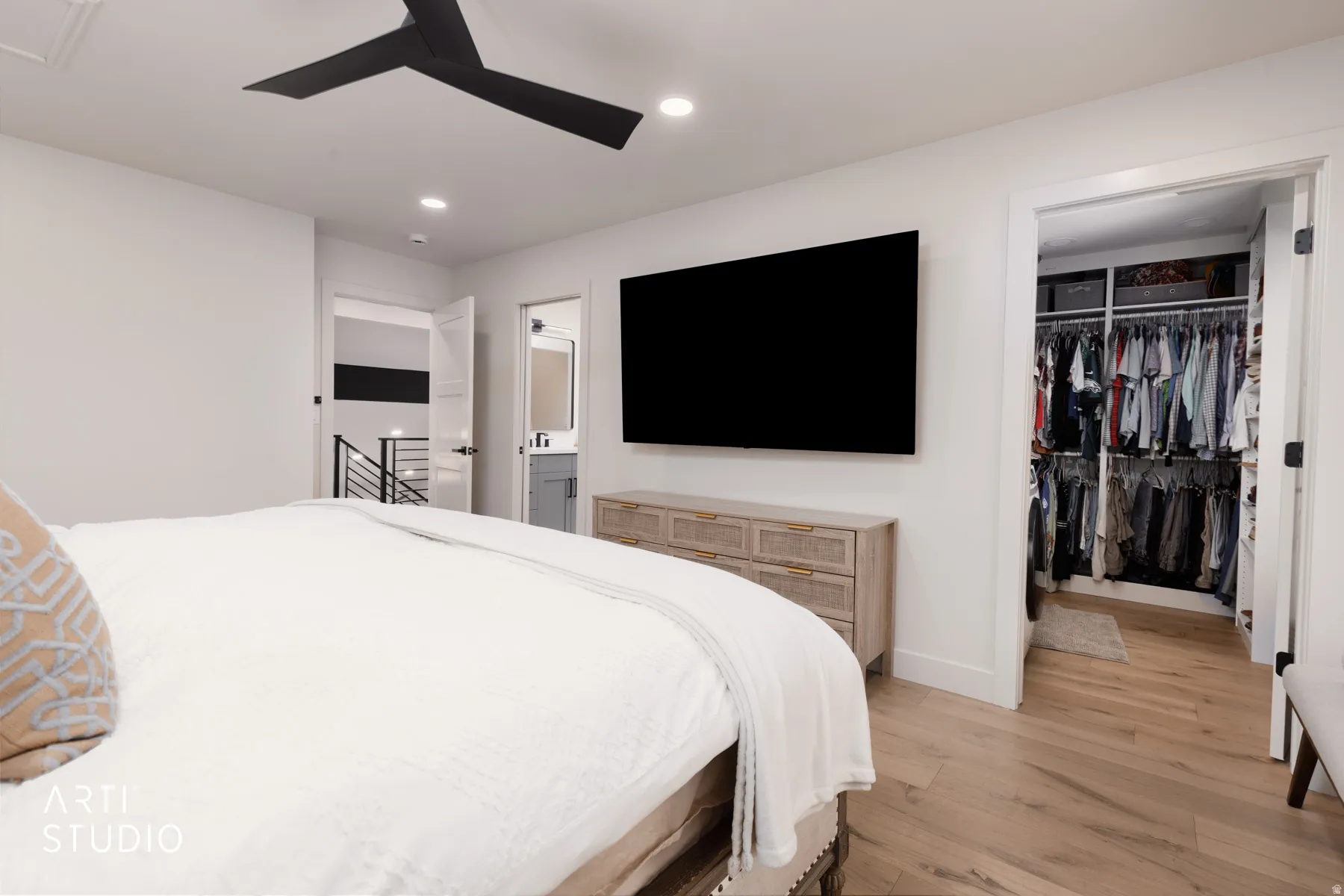 Wood-finish flooring, recessed lighting, and a black ceiling fan