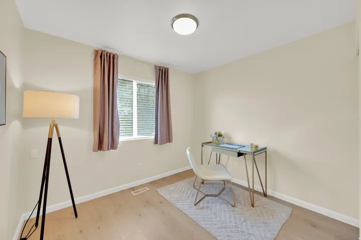 Recessed lighting, light wood-finish flooring, and a single window with blinds