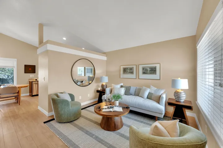 Light wood-finish flooring with a partial area rug