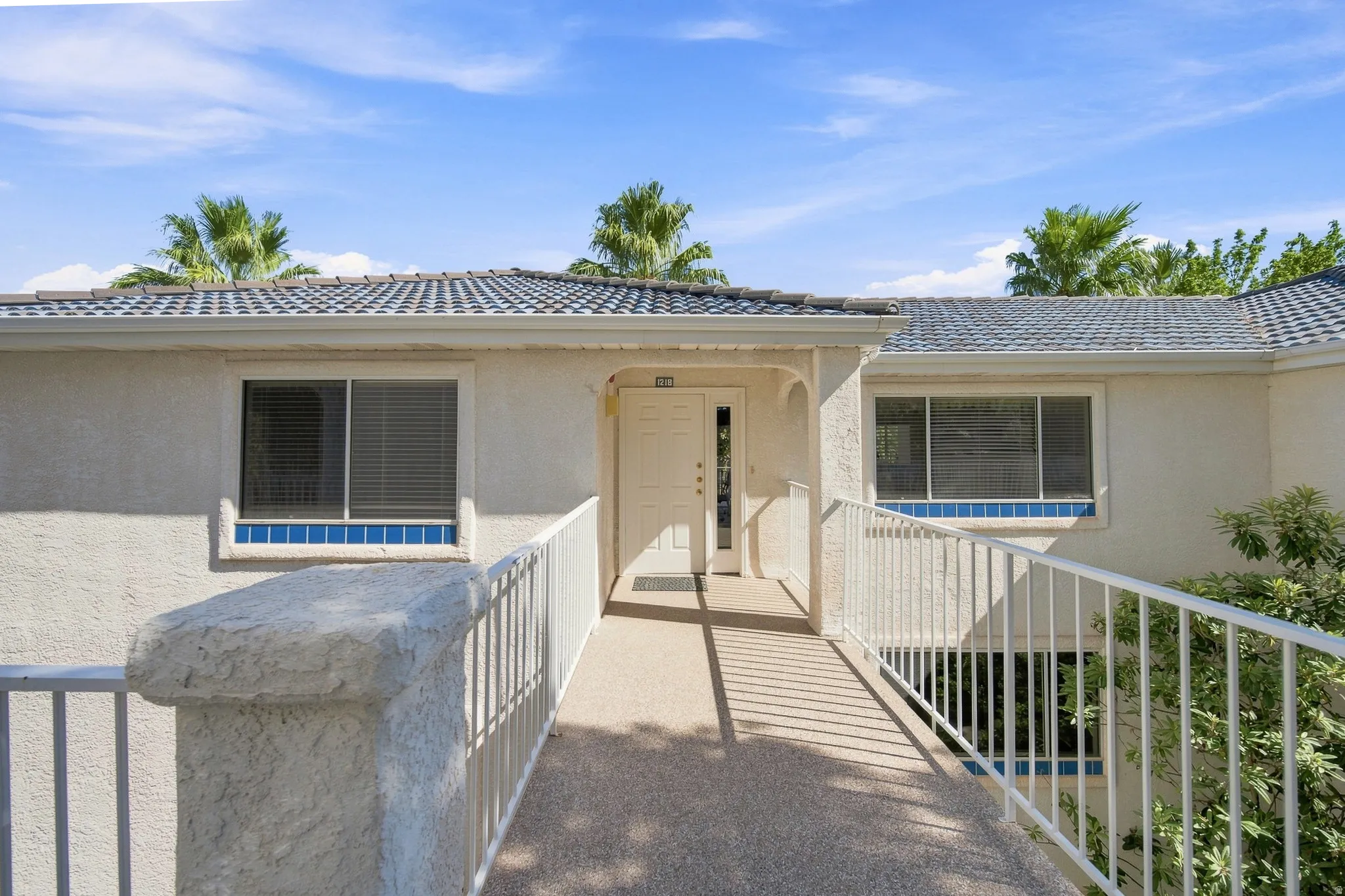 Stucco exterior with a tiled roof