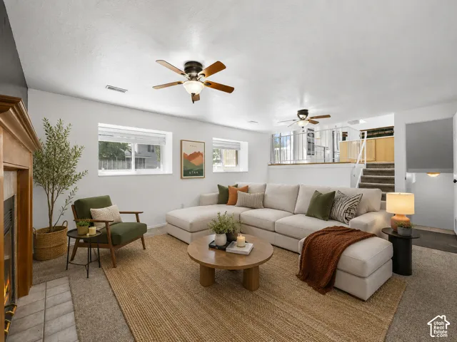 Wood-mantled fireplace, flush-mounted windows, and two ceiling fans