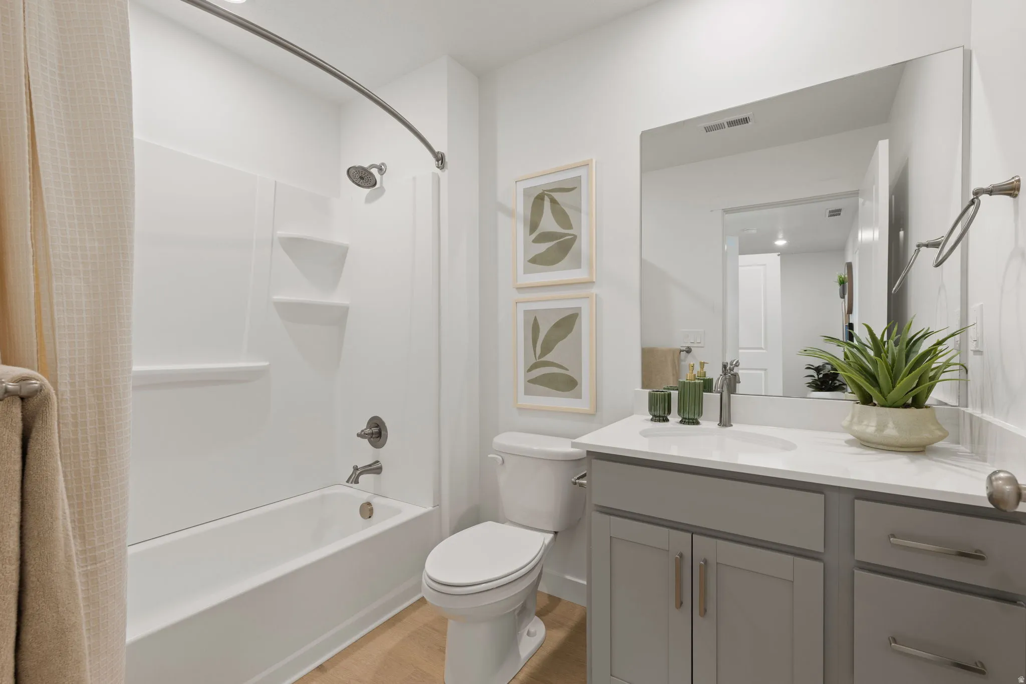 White tub and shower combination with a curved shower rod