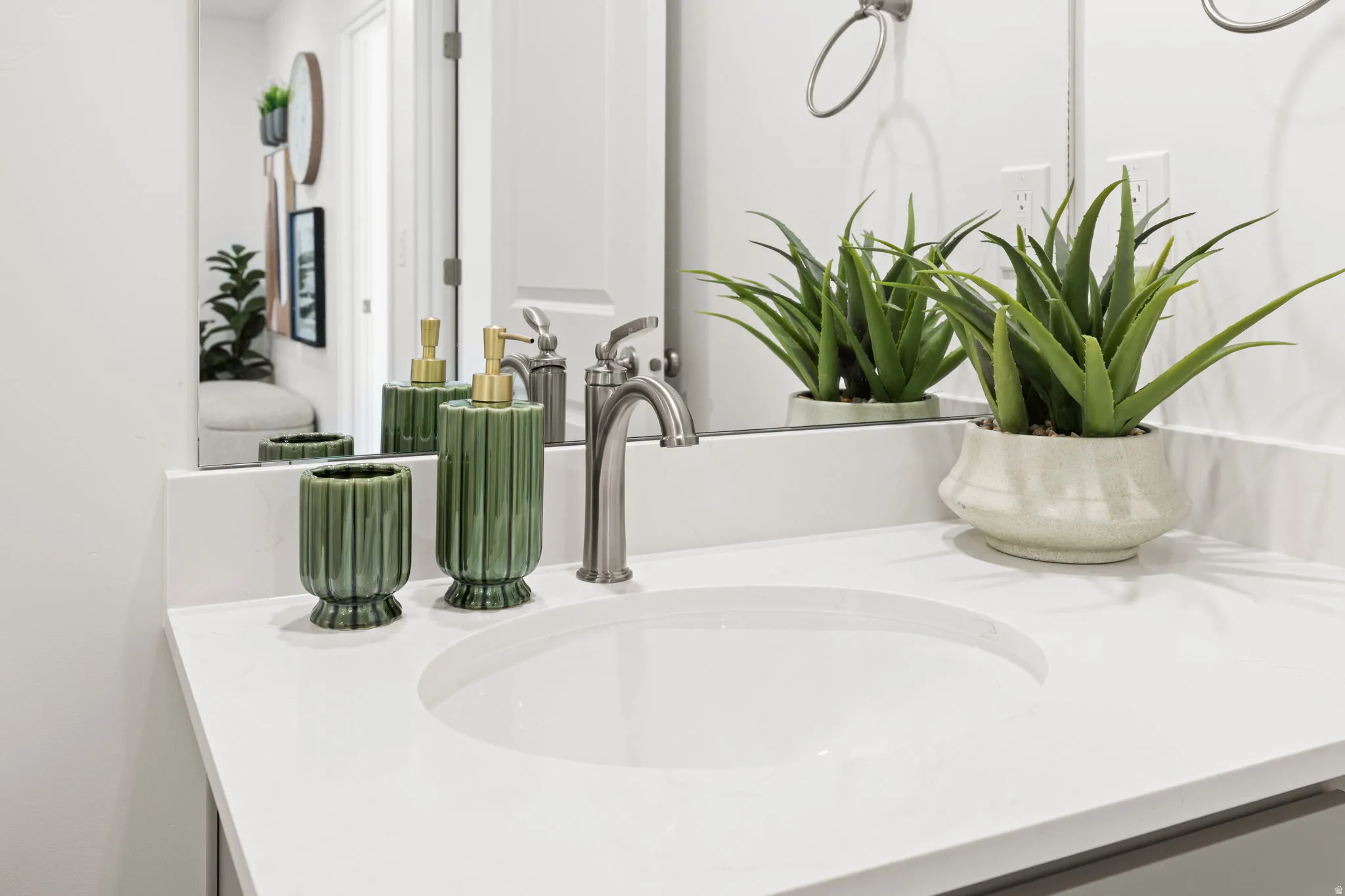 White countertop with an integrated sink and brushed nickel faucet