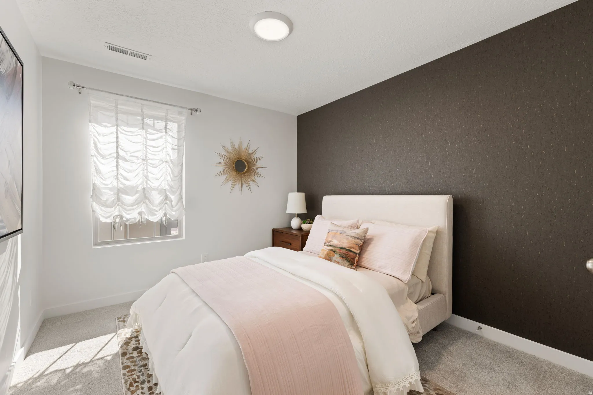Recessed window with sheer Roman shade, textured accent wall, and ceiling-mounted flush light fixture