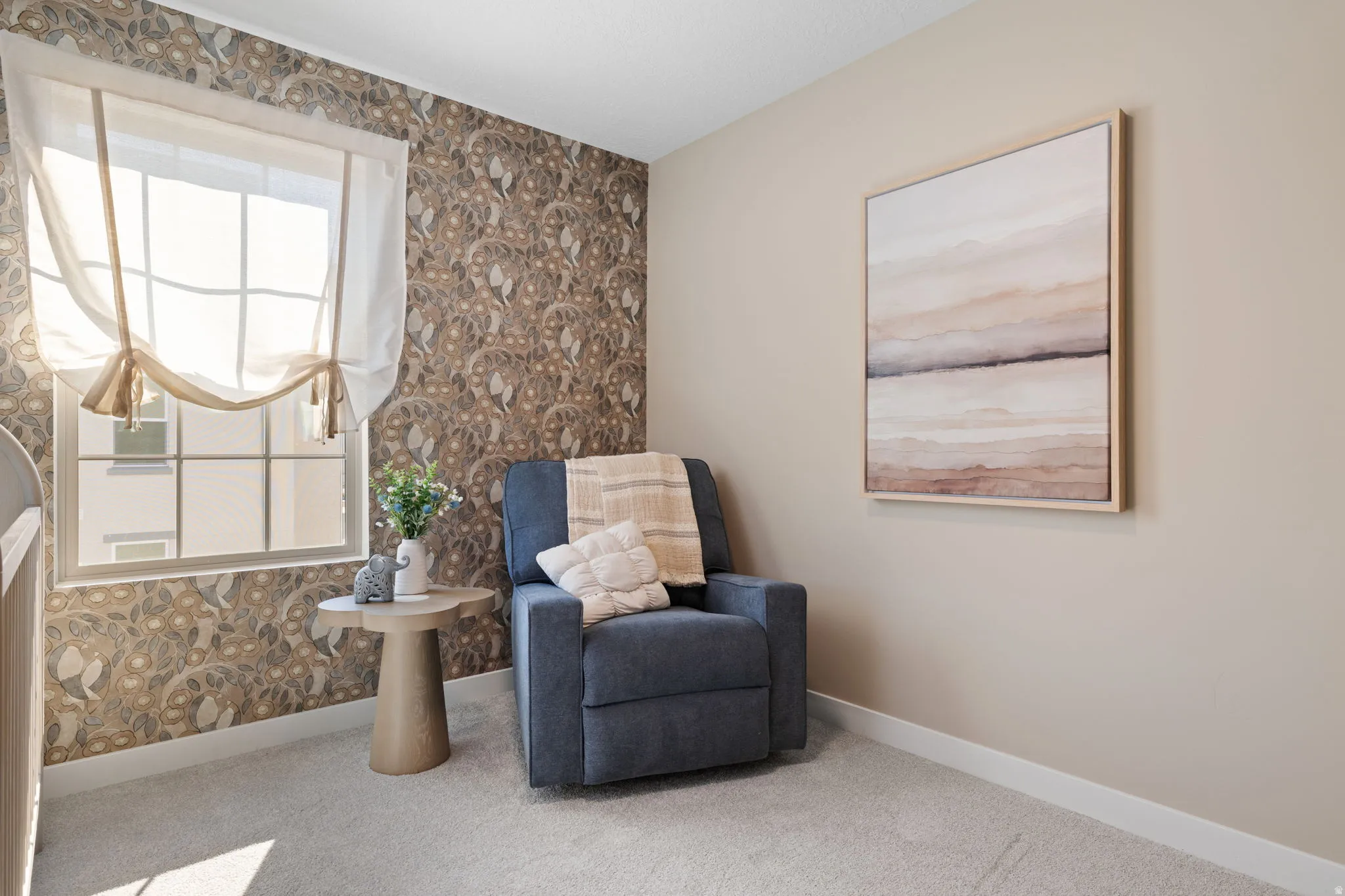 Window with a sheer Roman shade, patterned accent wall, light-colored carpeting, and neutral painted walls