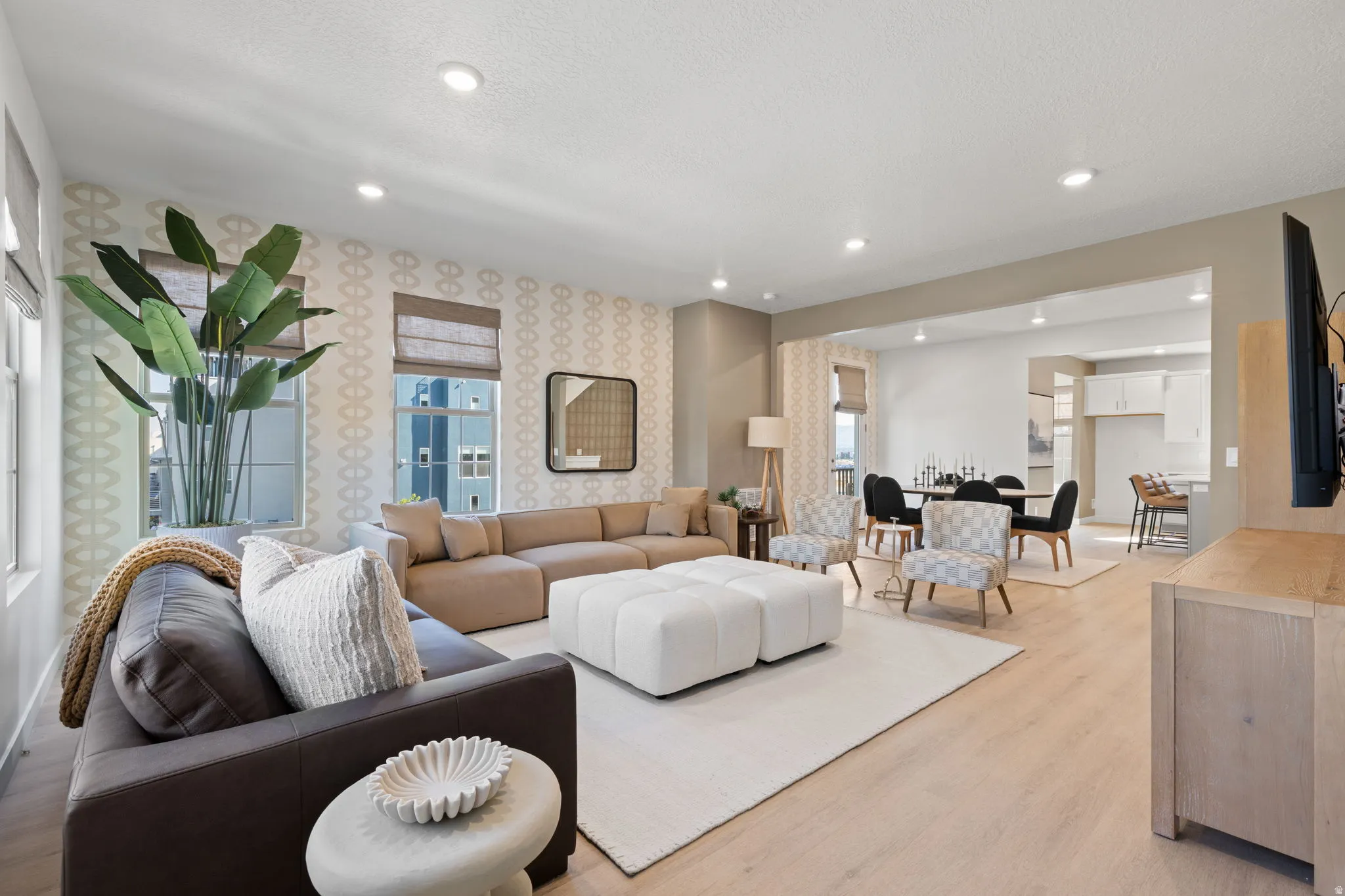 Recessed ceiling lighting, light wood-finish flooring, and an open concept layout