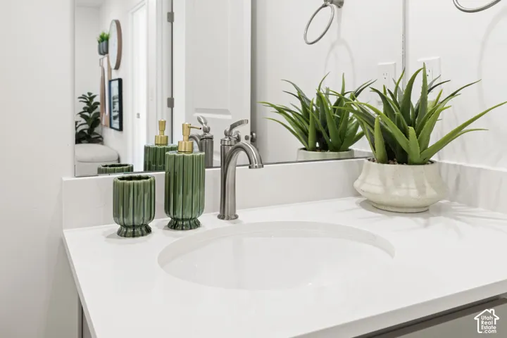 White countertop with an integrated sink and brushed nickel faucet