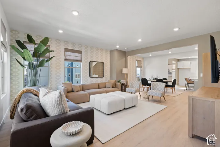Recessed ceiling lighting, light wood-finish flooring, and an open concept layout