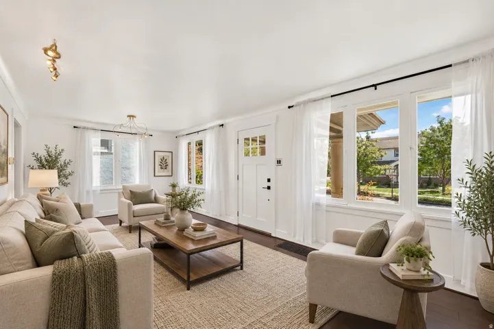 Hardwood flooring, multiple windows, recessed lighting, white trim, and a white paneled entry door