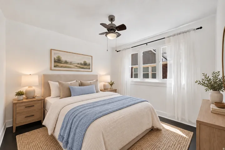 Ceiling fan with integrated lighting, dark wood-finish flooring, white walls, and a multi-pane window