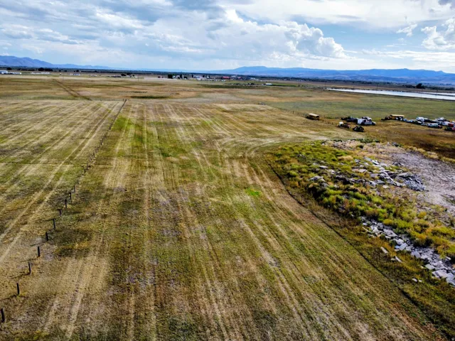 Expansive land offering a mix of cultivated fields and natural terrain