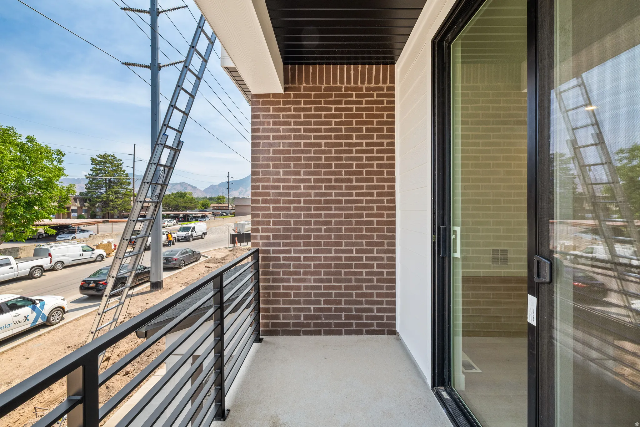 Private balcony featuring a black metal railing and a sliding glass door