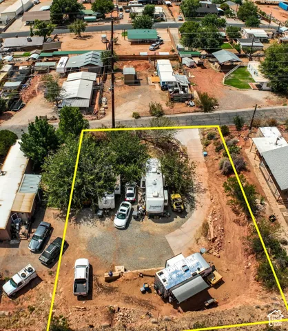 Expansive lot with mature trees, gravel parking area, and defined property boundaries. (lot lines are approximate)