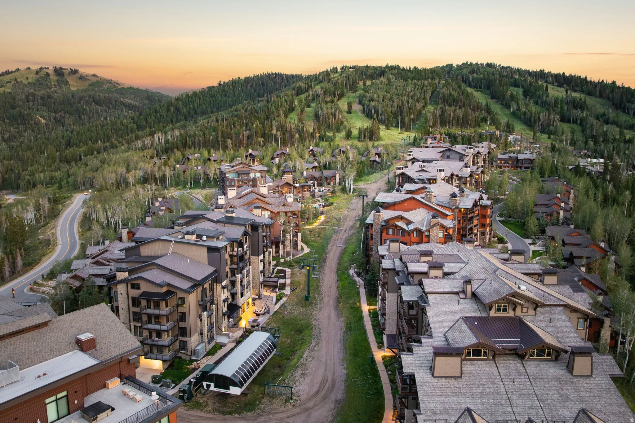 Mountain setting featuring extensive tree coverage and multiple multi-story structures