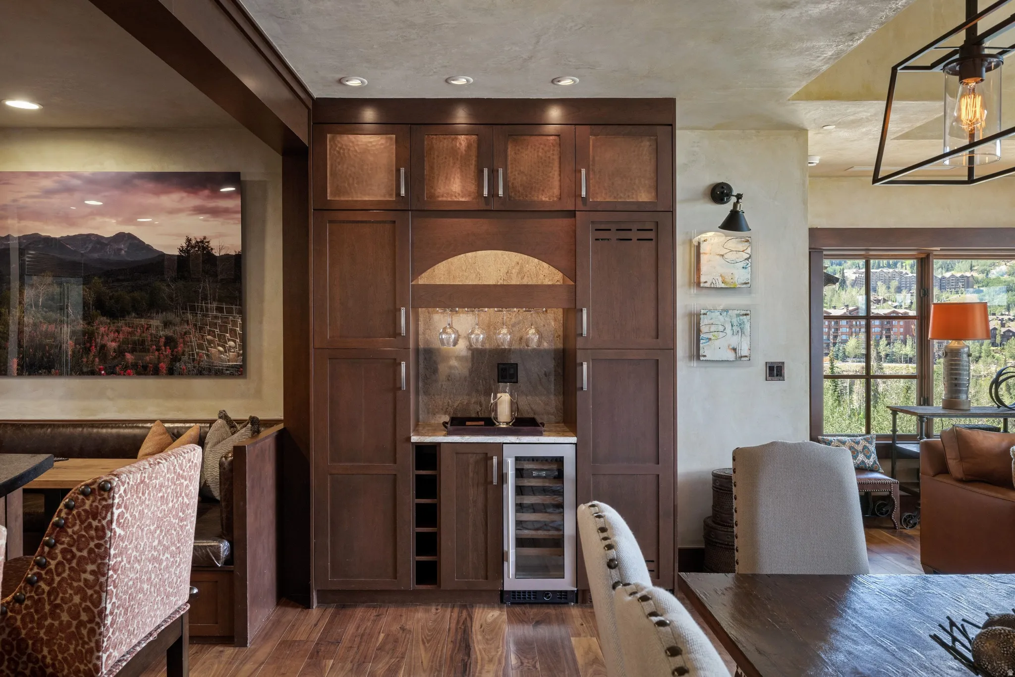 Built-in bar with wood cabinetry, integrated wine storage, and a beverage cooler