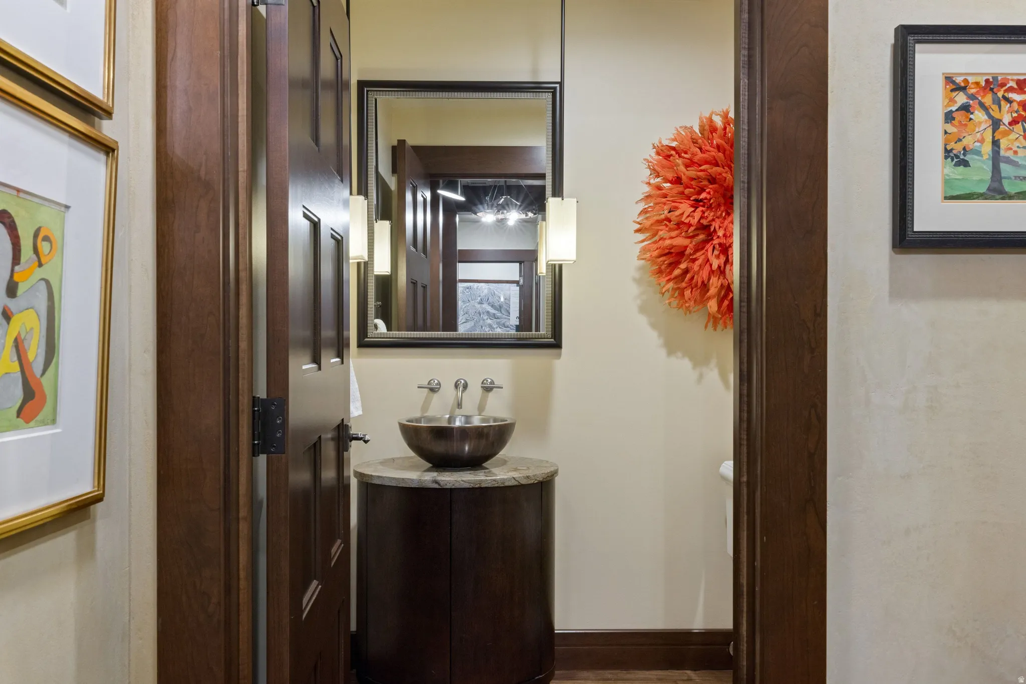 Wall-mounted vanity with a stone countertop and vessel sink