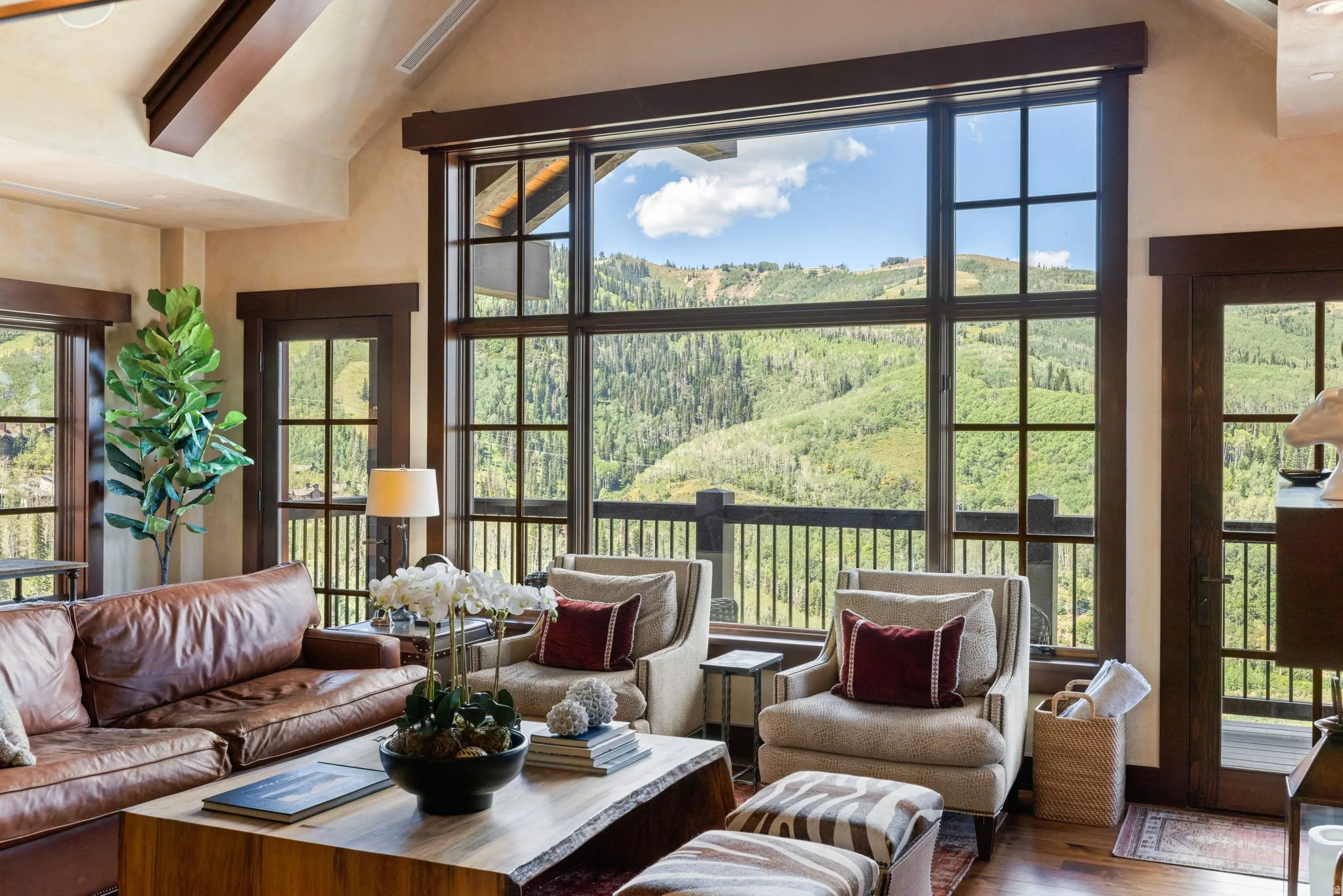 Vaulted ceiling with exposed wood beam and dark wood window frames