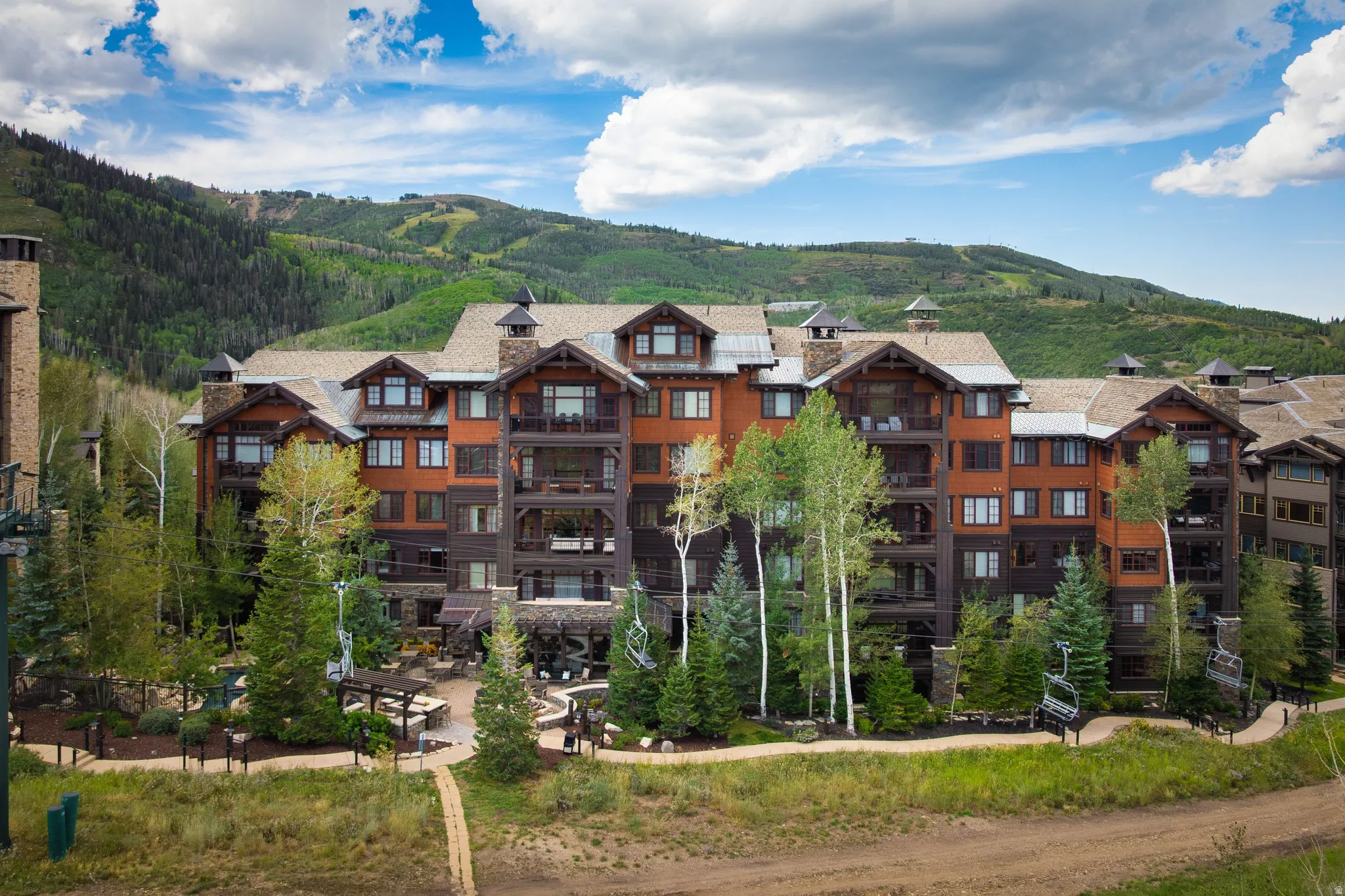 Multi-story building featuring stone and wood siding