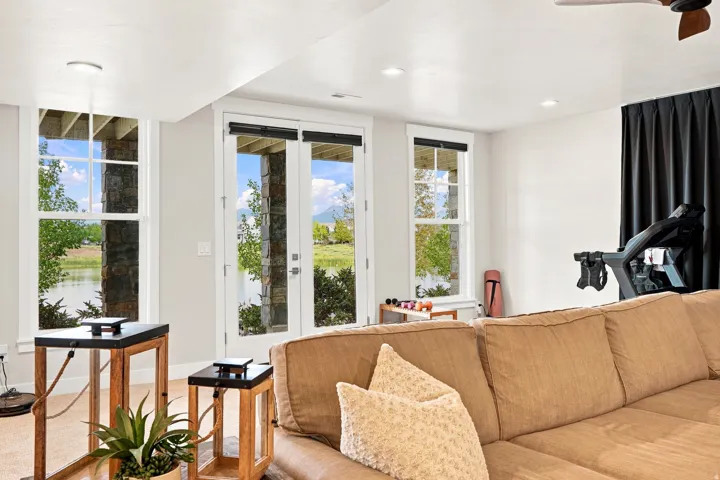 White walls with recessed lighting, multiple windows with white trim, and a white French door