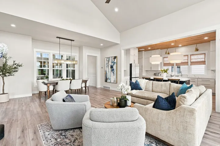 Expansive great room featuring vaulted ceilings, wood-finish flooring, and recessed lighting