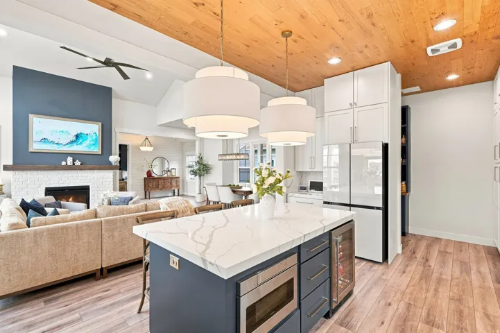 Open concept living area with wood-finish flooring