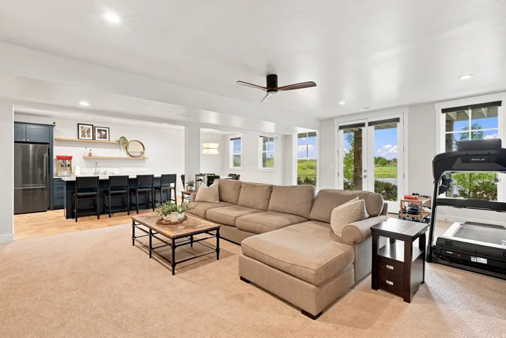 Spacious living area featuring recessed lighting, a ceiling fan, and light-toned carpeting