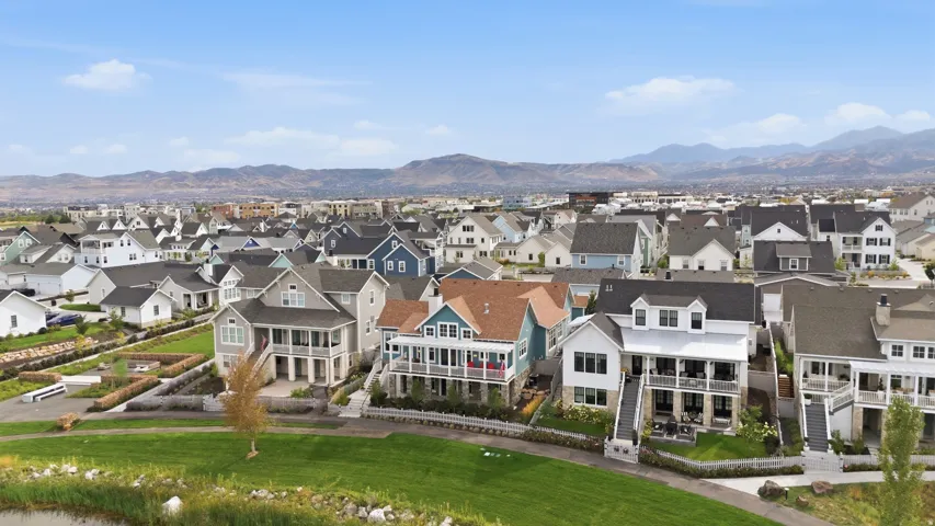 Community of residences featuring varied architectural styles and mountain backdrops
