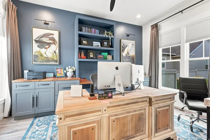 Built-in cabinetry with wood-finish countertops, integrated shelving, large windows with blinds, and recessed lighting