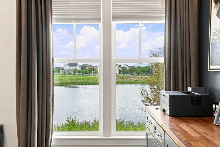Dual pane windows with cellular blinds and drapery panels