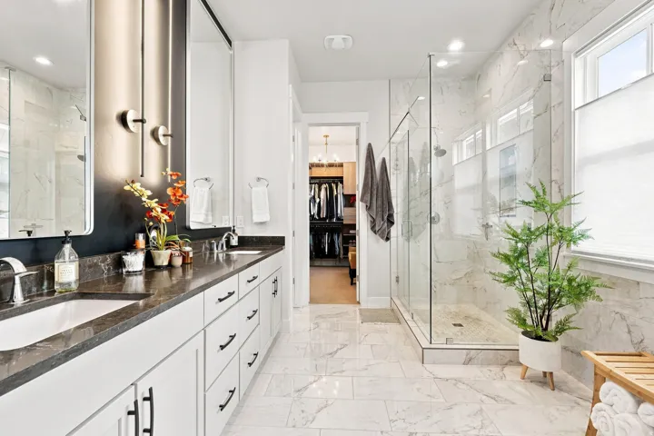 Dual vanity with dark countertops and integrated sinks