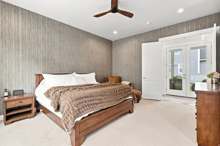 Wood-finish ceiling fan with integrated lighting, recessed ceiling lights, and textured wall covering