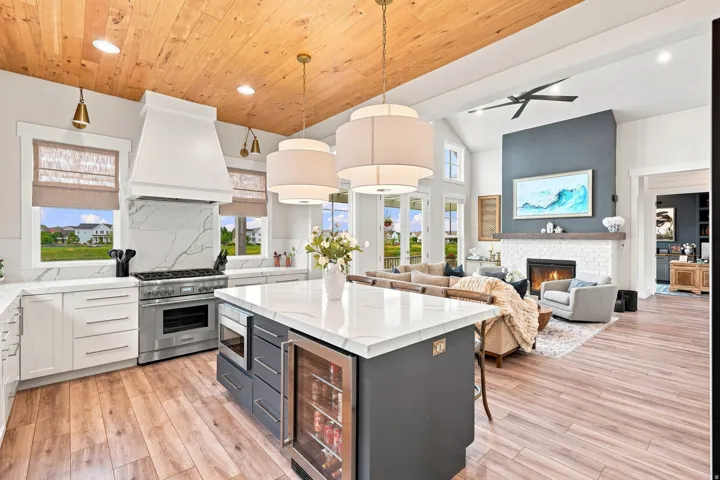 Chef's kitchen featuring a large range, quartz countertops, and a wood-paneled ceiling