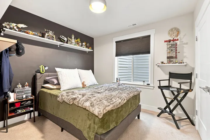 Recessed window with privacy blinds, dual-tone wall finishes, overhead flush mount lighting, and built-in shelving