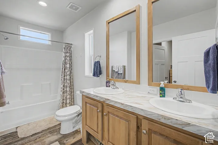Dual vanity with wood-finish cabinetry  in Master bedroom.