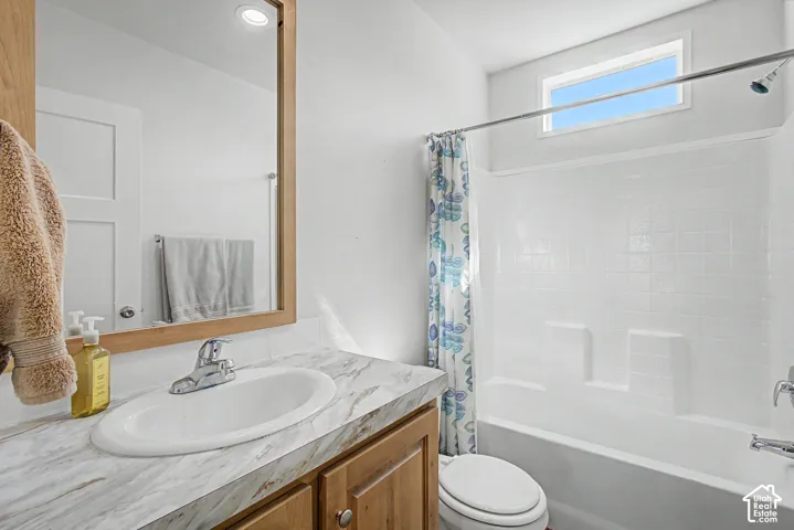 Guest Bathroom featuring a wood-finish vanity.
