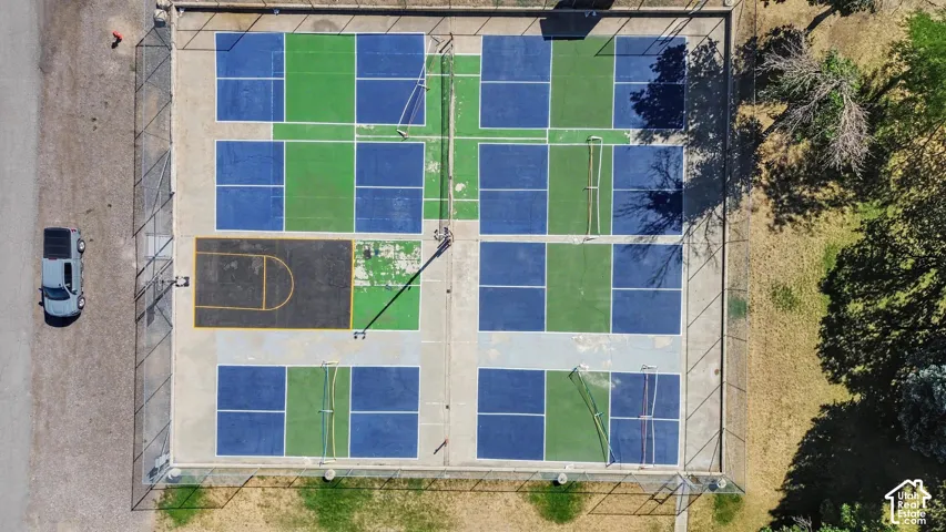 Multiple pickleball courts with painted blue and green playing surfaces