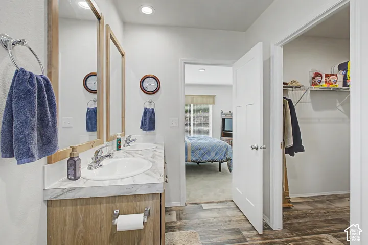 Dual vanity with wood-finish cabinetry and chrome fixtures