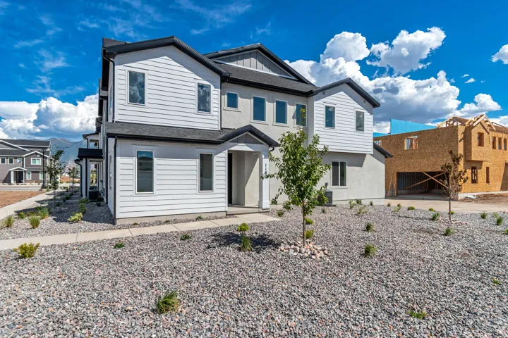 Modern multi-story facade featuring horizontal siding and stucco accents