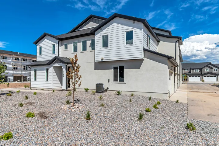Contemporary exterior featuring white siding and stucco finishes