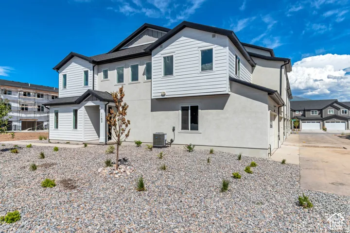 Contemporary exterior featuring white siding and stucco finishes