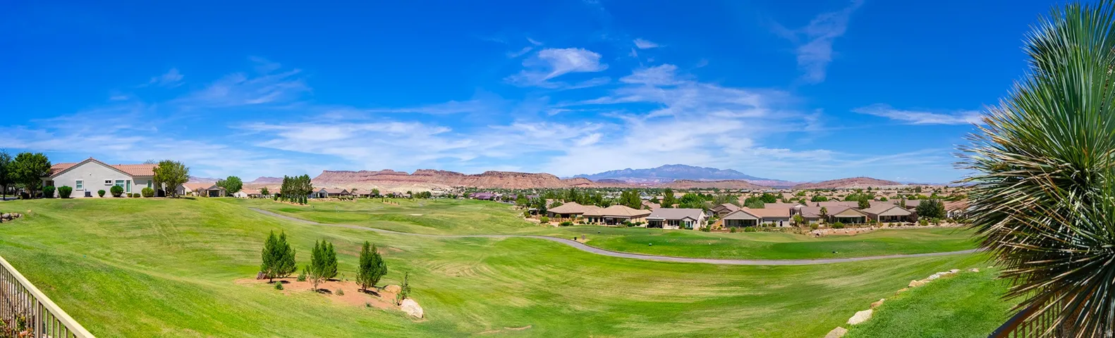 Expansive golf course setting featuring manicured greens and surrounding residential properties