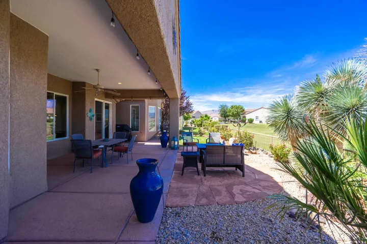 Expansive covered patio featuring a ceiling fan, recessed lighting, and direct access to the landscaped yard