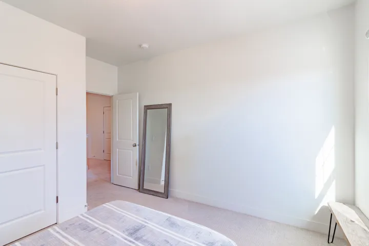 Wall-to-wall carpeting and white walls