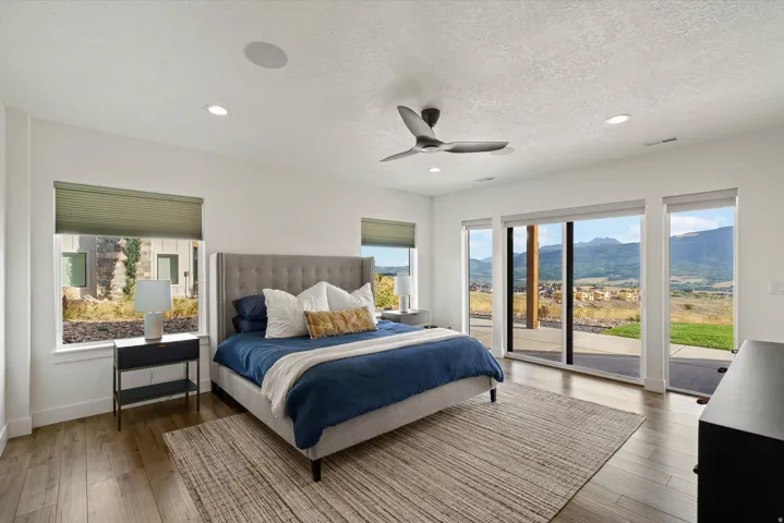 Wood-finish flooring, recessed lighting, and a ceiling fan